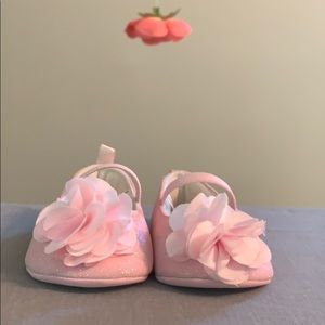 Pink shimmery baby shoes.